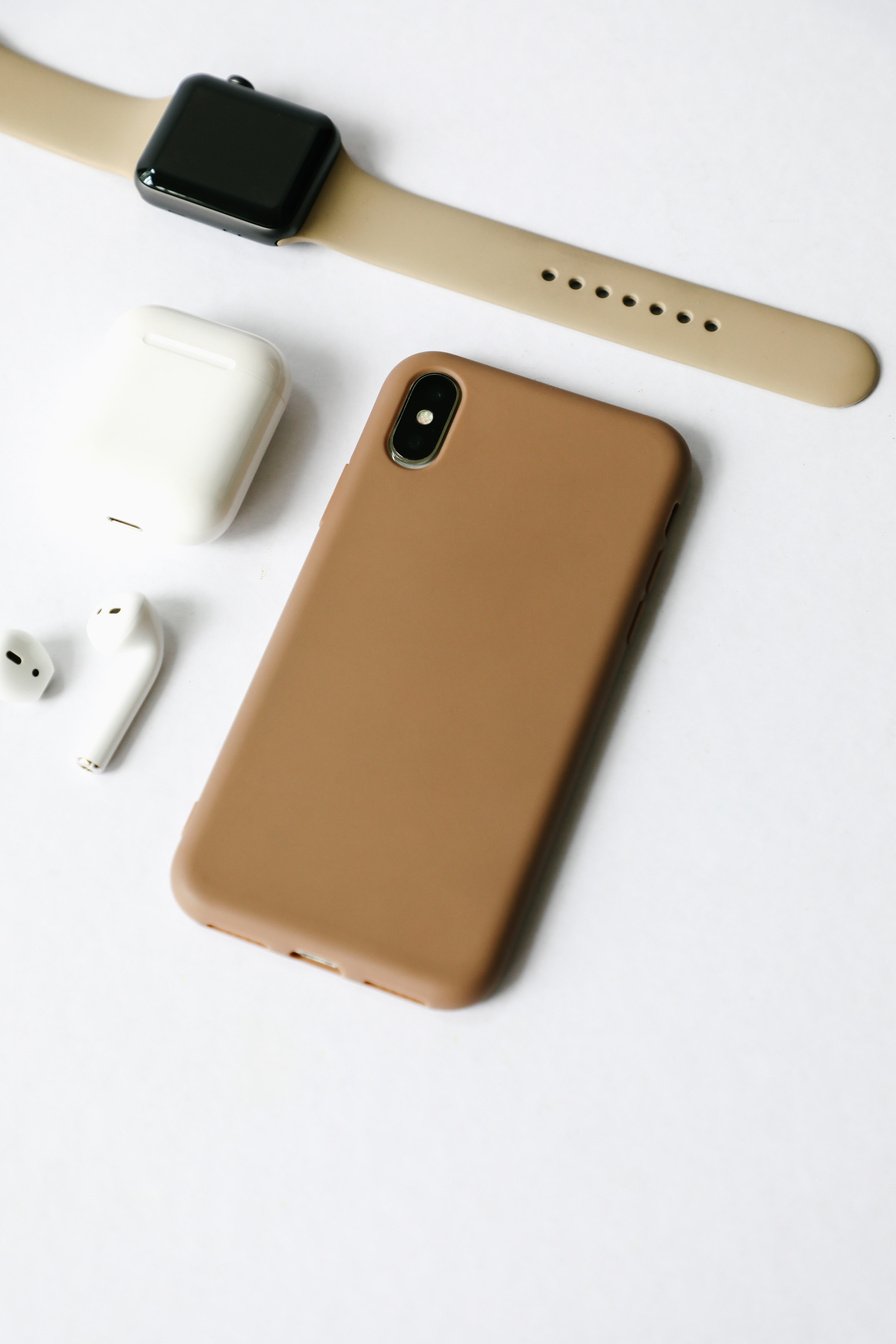 Mobile Phone with Brown Case with other Gadgets and Accessories