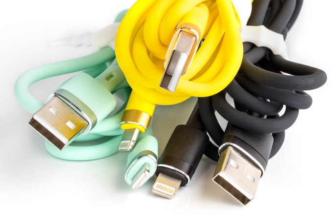 Set of colored usb cables for charging a mobile phone on a white background. mobile phone accessory